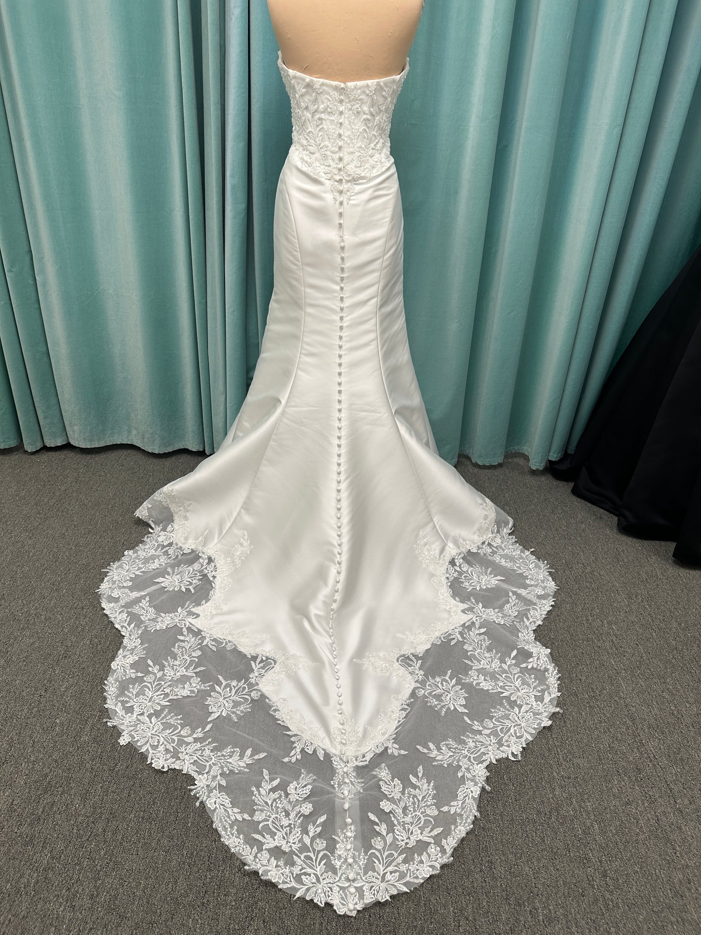 Strapless Mikado fit-and-flare wedding dress with corset bodice, exposed boning, lace detailing, and dramatic lace train by Stella York Style SY8163