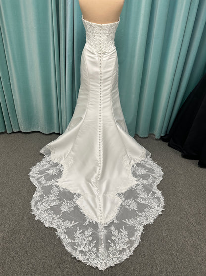 Strapless Mikado fit-and-flare wedding dress with corset bodice, exposed boning, lace detailing, and dramatic lace train by Stella York Style SY8163