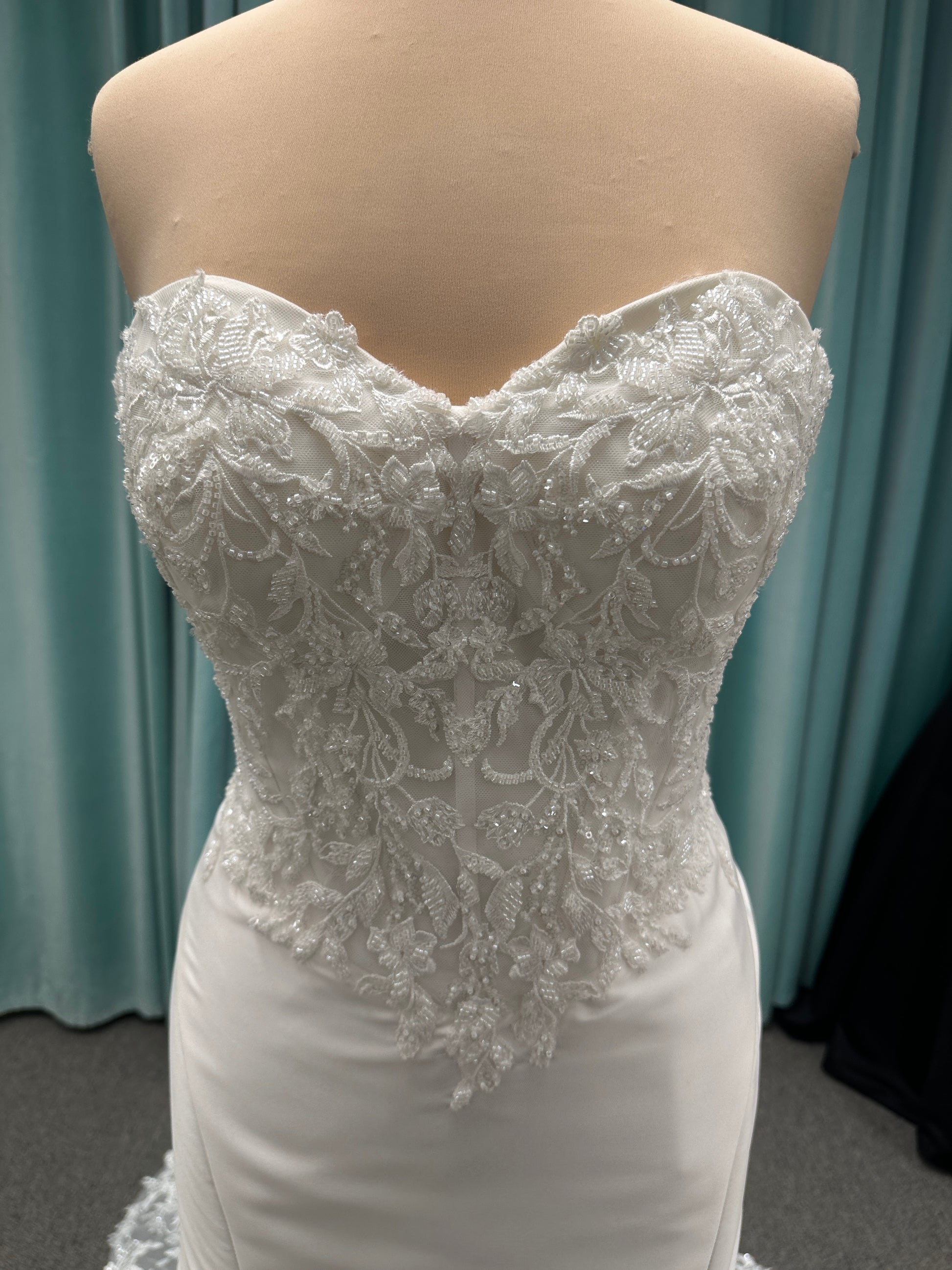 Strapless Mikado fit-and-flare wedding dress with corset bodice, exposed boning, lace detailing, and dramatic lace train by Stella York Style SY8163