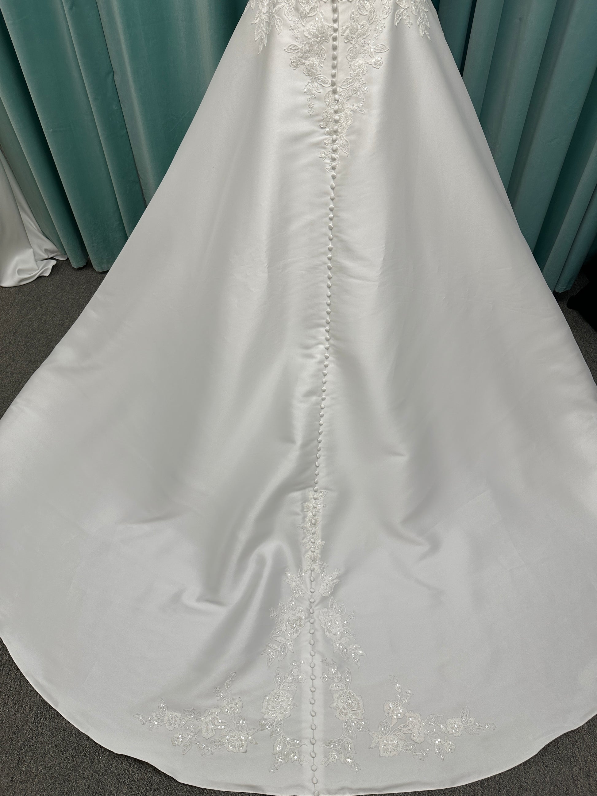 Plus size Stella York 7897 wedding dress in Mikado fabric with square neckline, lace bodice, side cutouts, and flowing A-line skirt with pockets