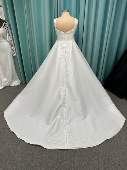 Plus size Stella York 7897 wedding dress in Mikado fabric with square neckline, lace bodice, side cutouts, and flowing A-line skirt with pockets