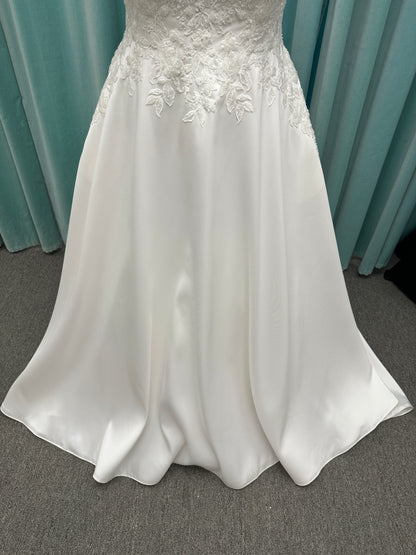 Plus size Stella York 7897 wedding dress in Mikado fabric with square neckline, lace bodice, side cutouts, and flowing A-line skirt with pockets