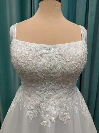 Plus size Stella York 7897 wedding dress in Mikado fabric with square neckline, lace bodice, side cutouts, and flowing A-line skirt with pockets