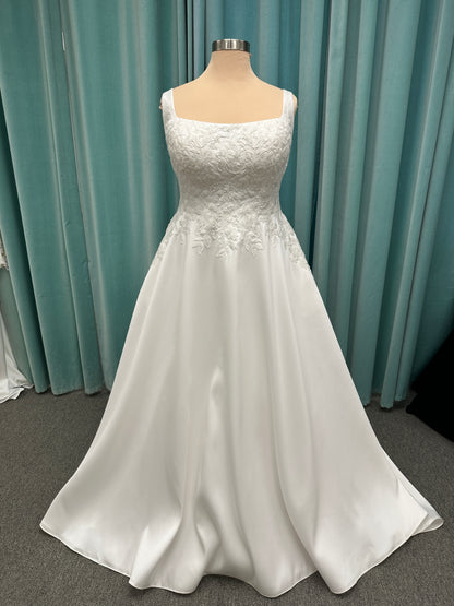 Plus size Stella York 7897 wedding dress in Mikado fabric with square neckline, lace bodice, side cutouts, and flowing A-line skirt with pockets
