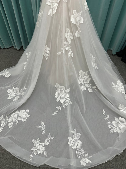Strapless lace A-line wedding dress with sweetheart neckline, sheer corset bodice, and oversized floral lace appliqués by Stella York Style 7975