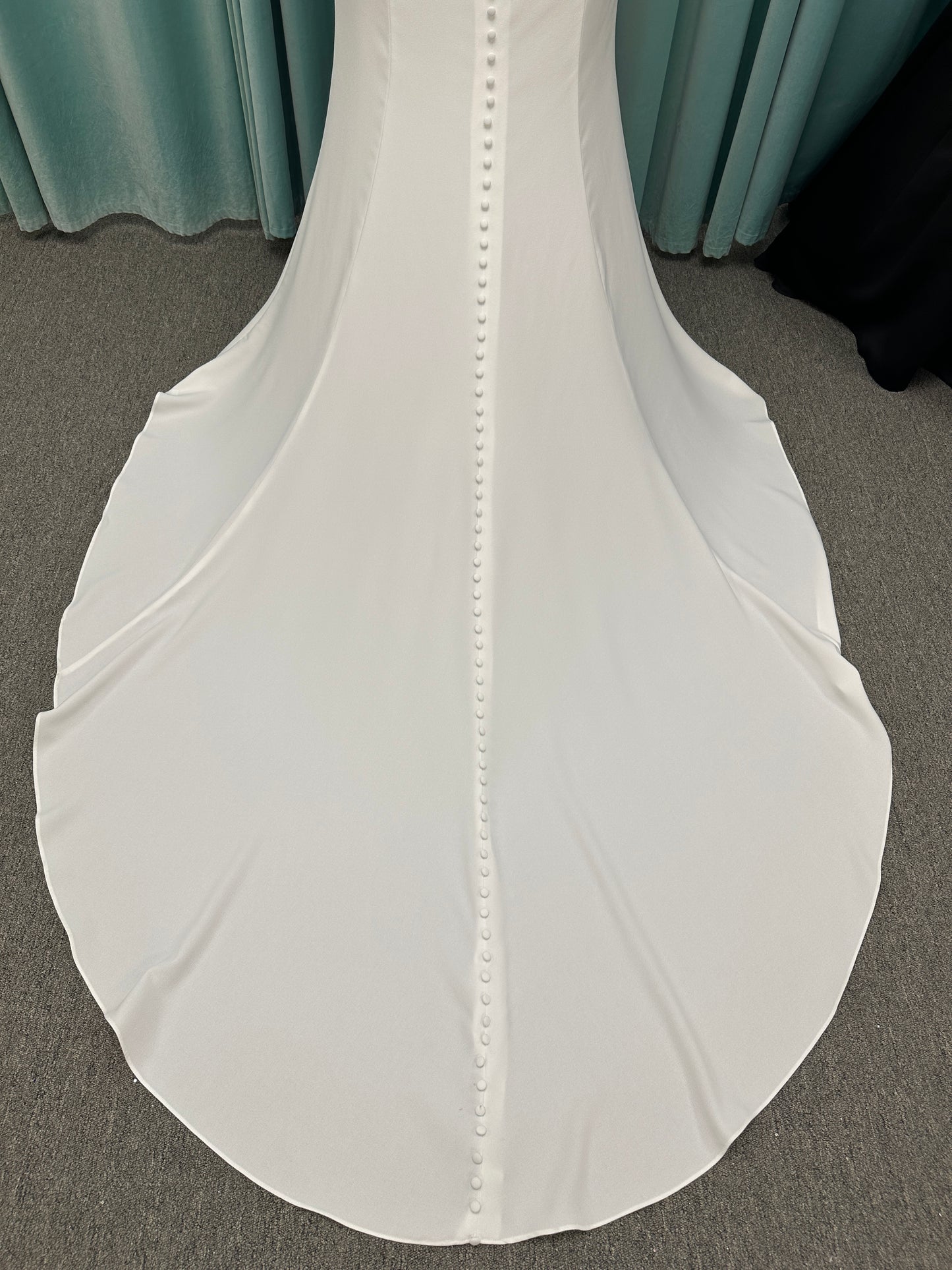 Stella York 7774 column sheath wedding dress with plunging neckline, lace appliqués, side cutouts, and crepe skirt with train