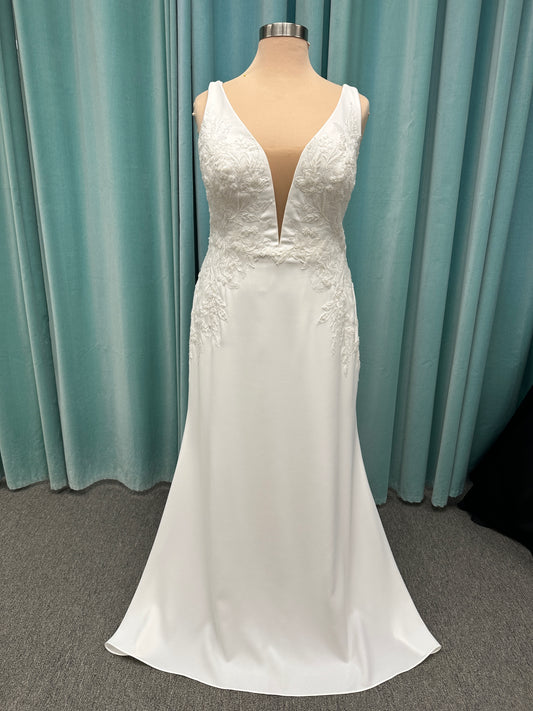 Stella York 7774 column sheath wedding dress with plunging neckline, lace appliqués, side cutouts, and crepe skirt with train