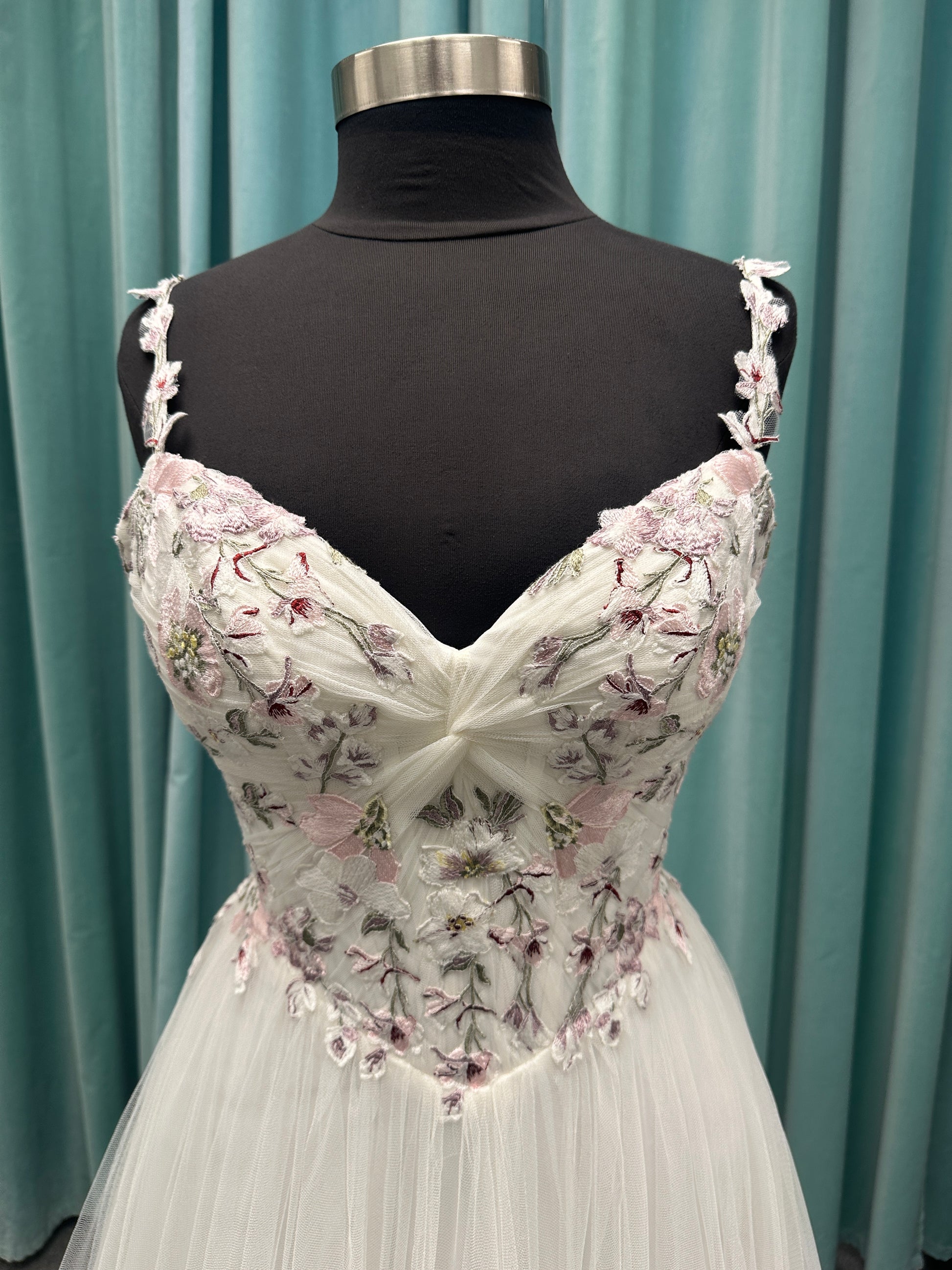 Stella York SY8113 colorful embroidered A-line wedding dress with twisted knot sweetheart neckline, sheer bodice, and soft pink tulle skirt