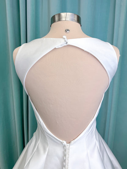 Morilee 1050007 Sylvia modest A-line wedding dress on mannequin with high neckline, crystal and pearl beaded embroidery, and flowing chiffon skirt