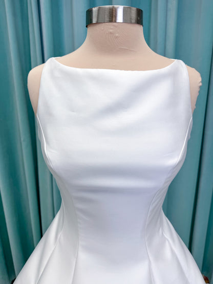 Morilee 1050007 Sylvia modest A-line wedding dress on mannequin with high neckline, crystal and pearl beaded embroidery, and flowing chiffon skirt