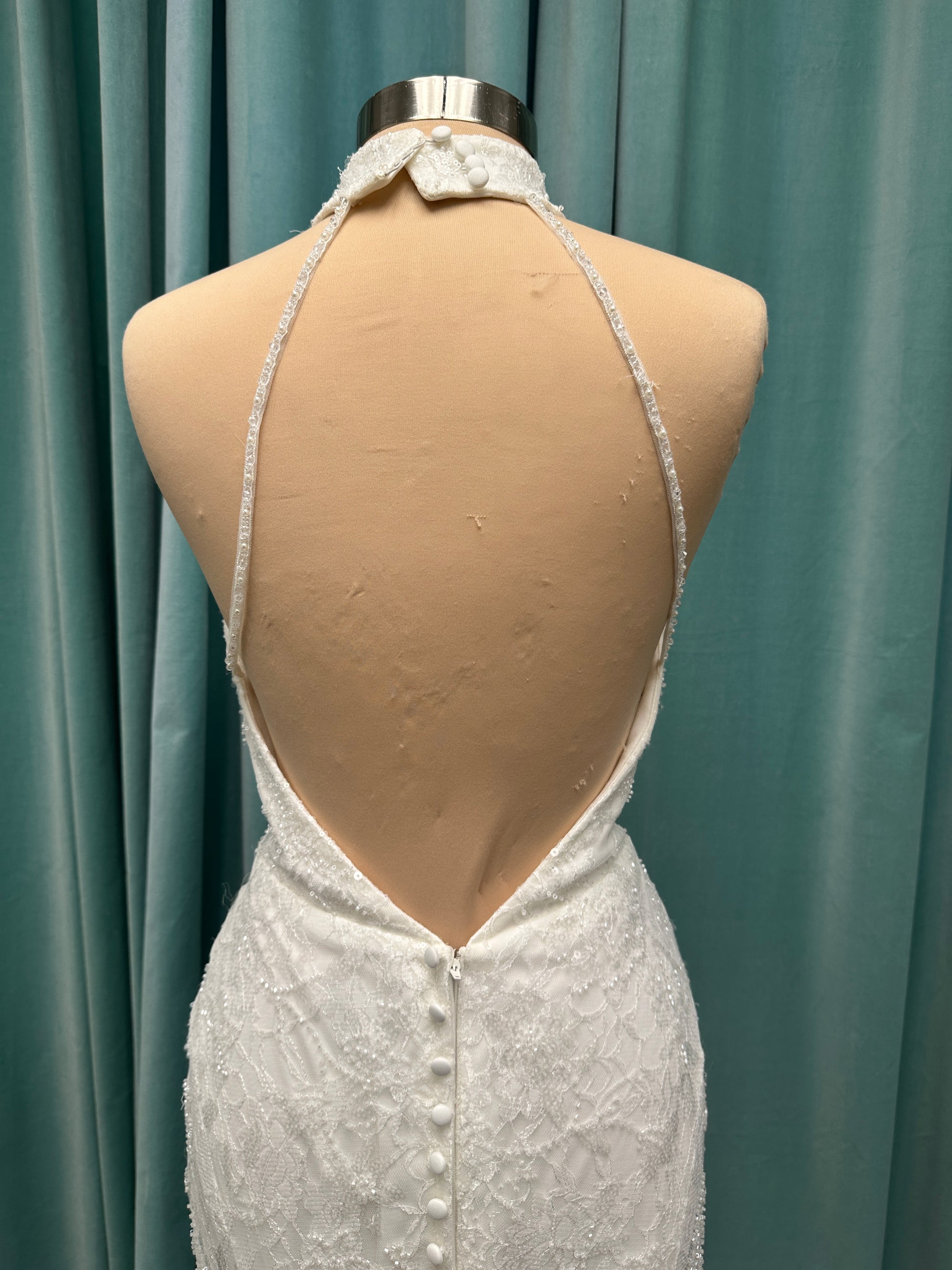 Stella York 7954 halter wedding dress with embellished floral lace, beaded detail, and fitted column silhouette with low back