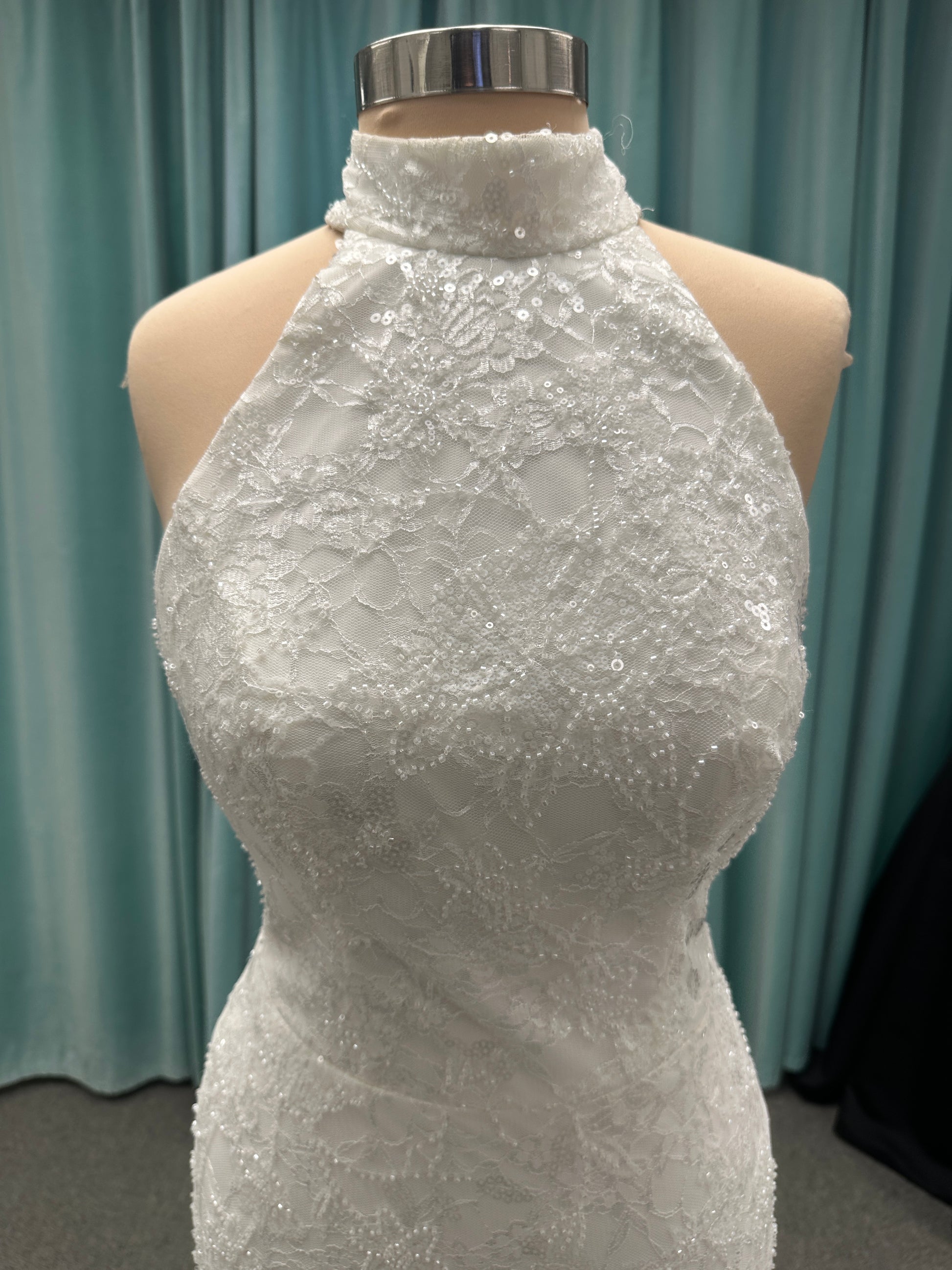 Stella York 7954 halter wedding dress with embellished floral lace, beaded detail, and fitted column silhouette with low back