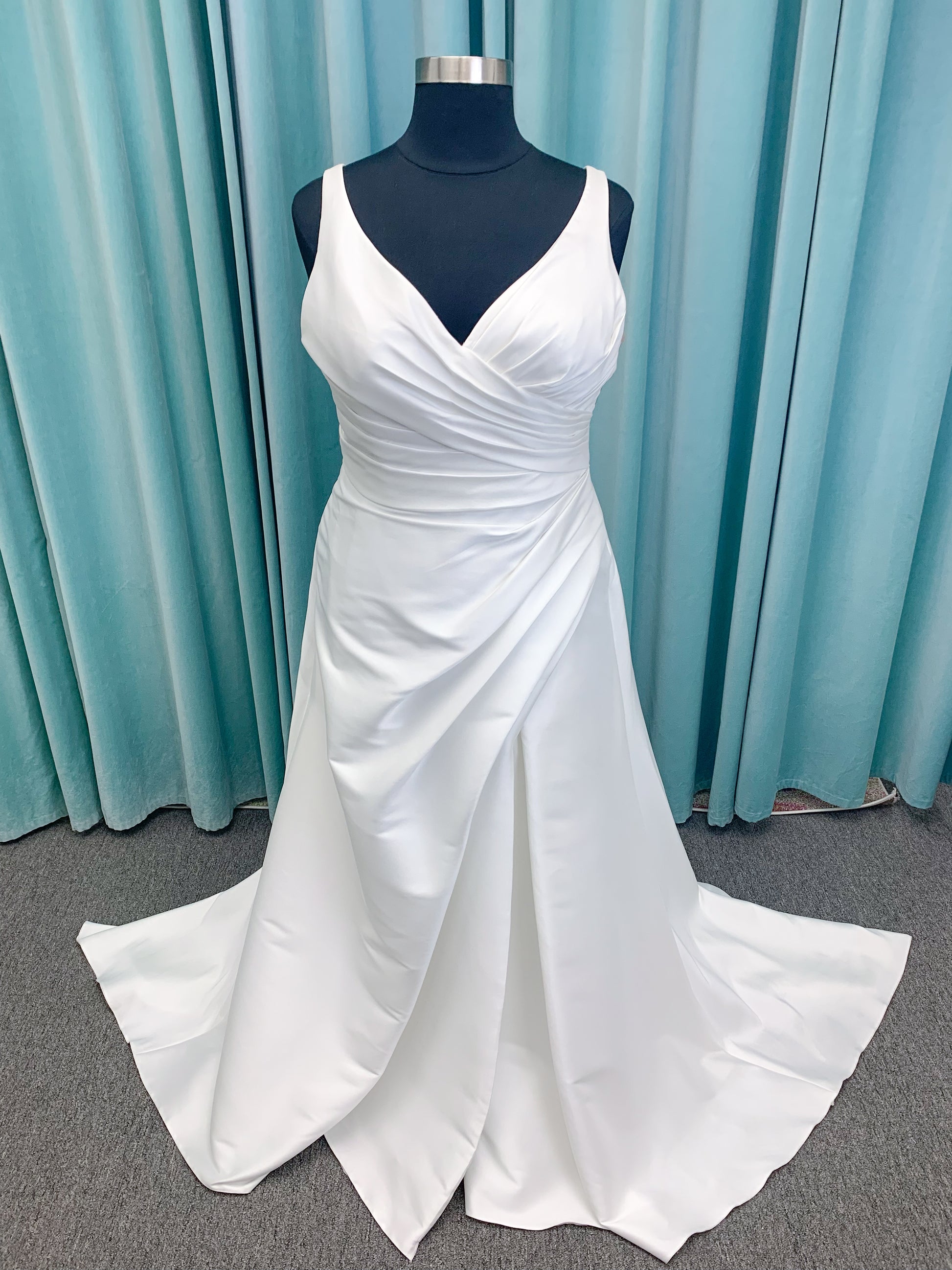 Morilee 3437 Tia plus size A-line wedding dress in stretch Larissa satin with V-neckline, sheer corset back, front slit, and classic buttons to hem.