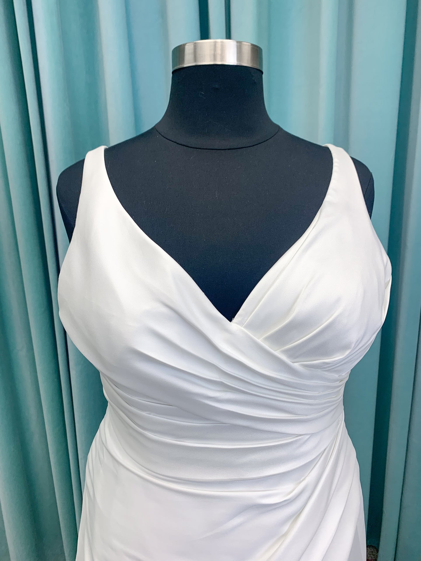 Morilee 3437 Tia plus size A-line wedding dress in stretch Larissa satin with V-neckline, sheer corset back, front slit, and classic buttons to hem.