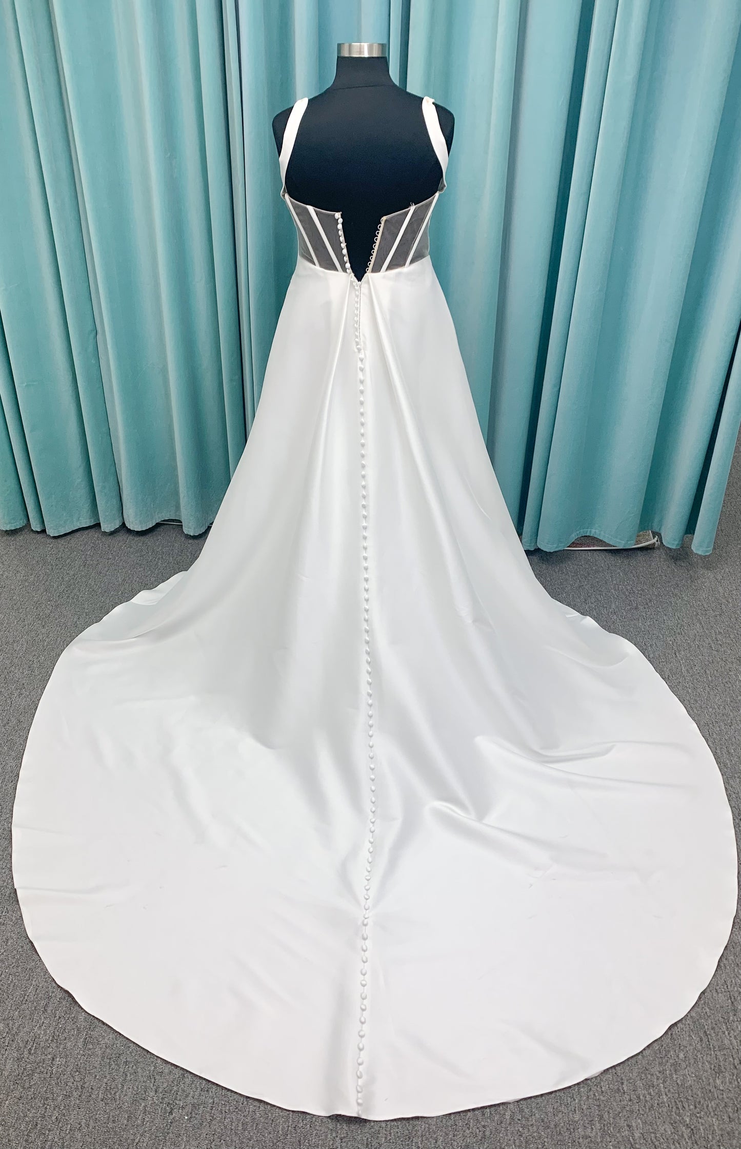 Morilee 3437 Tia plus size A-line wedding dress in stretch Larissa satin with V-neckline, sheer corset back, front slit, and classic buttons to hem.