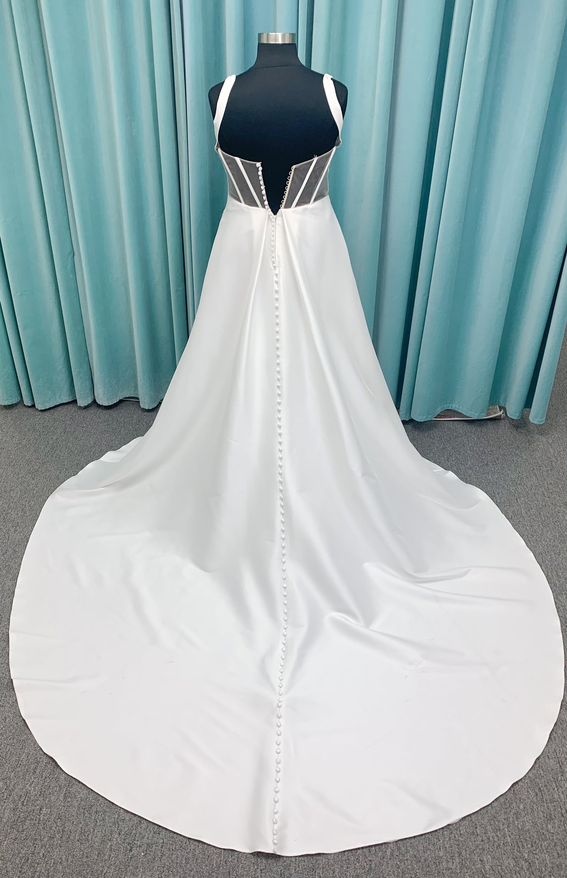 Morilee 3437 Tia plus size A-line wedding dress in stretch Larissa satin with V-neckline, sheer corset back, front slit, and classic buttons to hem.