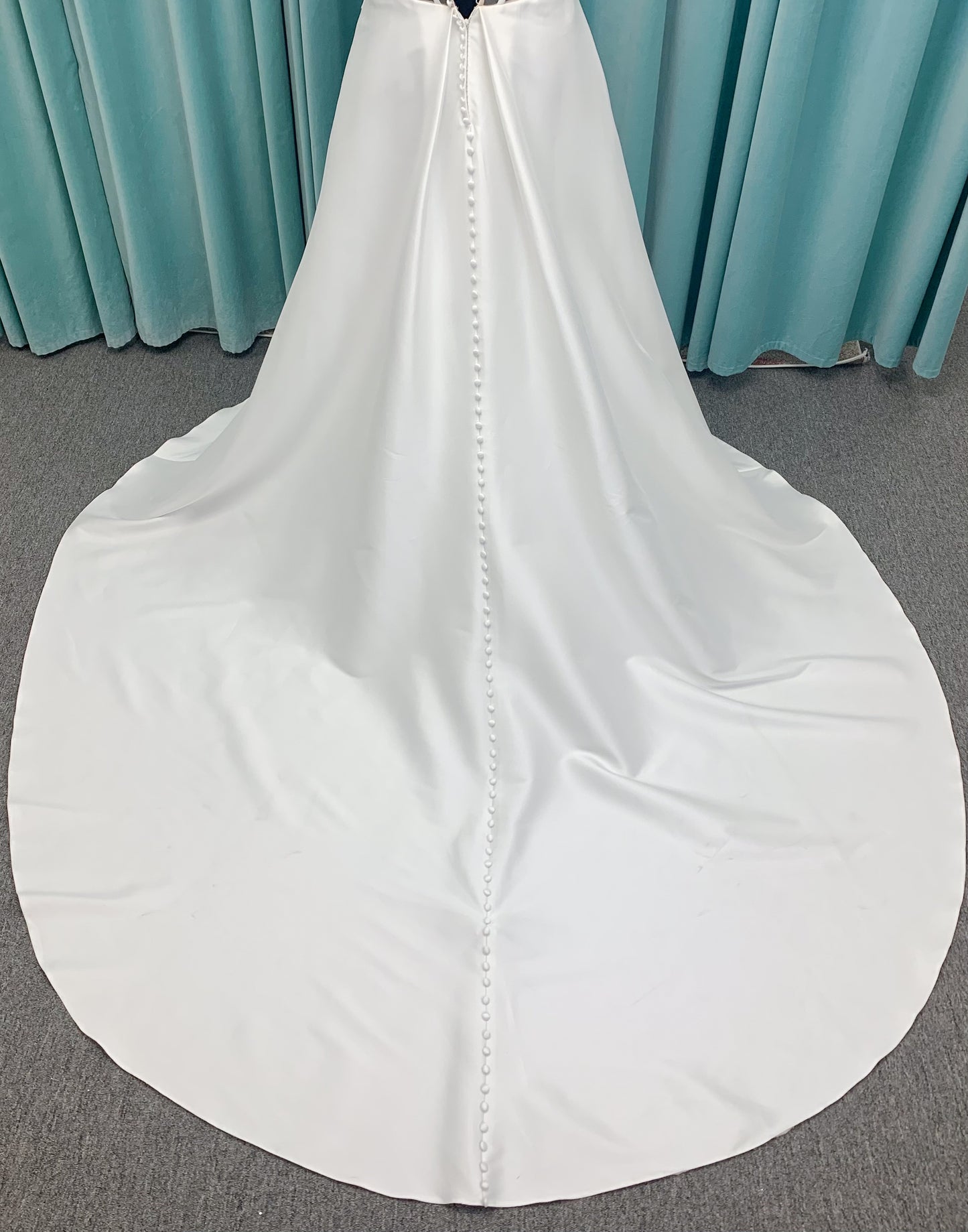 Morilee 3437 Tia plus size A-line wedding dress in stretch Larissa satin with V-neckline, sheer corset back, front slit, and classic buttons to hem.