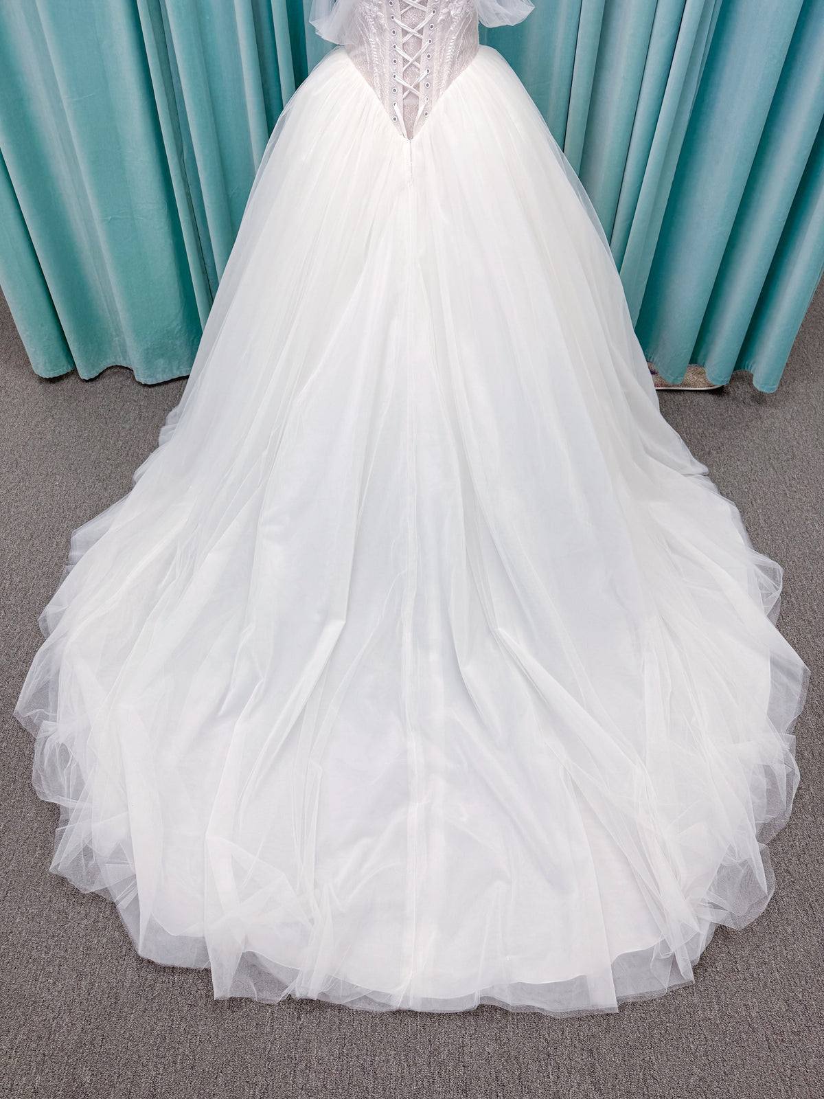Morilee 1010036 Virtuoso ballgown wedding dress on mannequin with scoop neckline, off-the-shoulder tulle sleeves, beaded bodice, and lace-up corset back