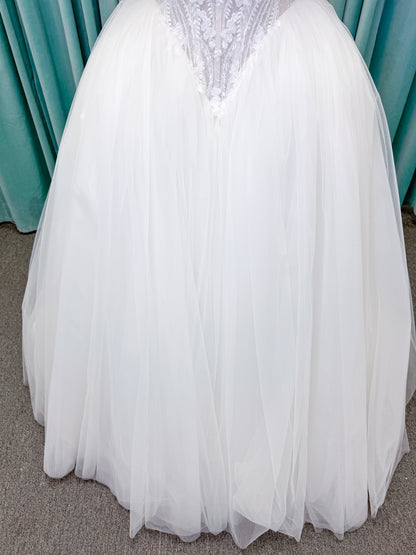 Morilee 1010036 Virtuoso ballgown wedding dress on mannequin with scoop neckline, off-the-shoulder tulle sleeves, beaded bodice, and lace-up corset back