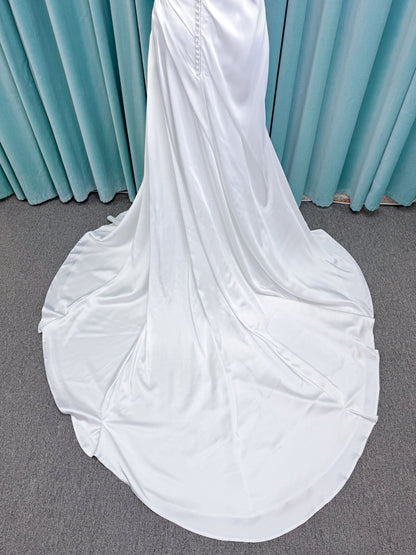 Morilee 2941 Zenobia fit and flare wedding dress on mannequin with strapless scoop neckline, asymmetric draped satin, and skirt slit