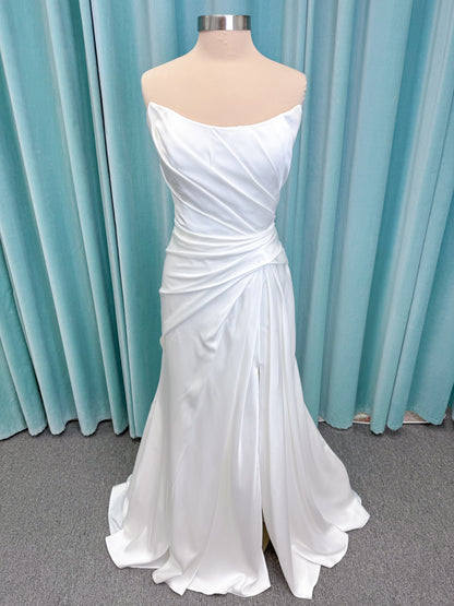 Morilee 2941 Zenobia fit and flare wedding dress on mannequin with strapless scoop neckline, asymmetric draped satin, and skirt slit