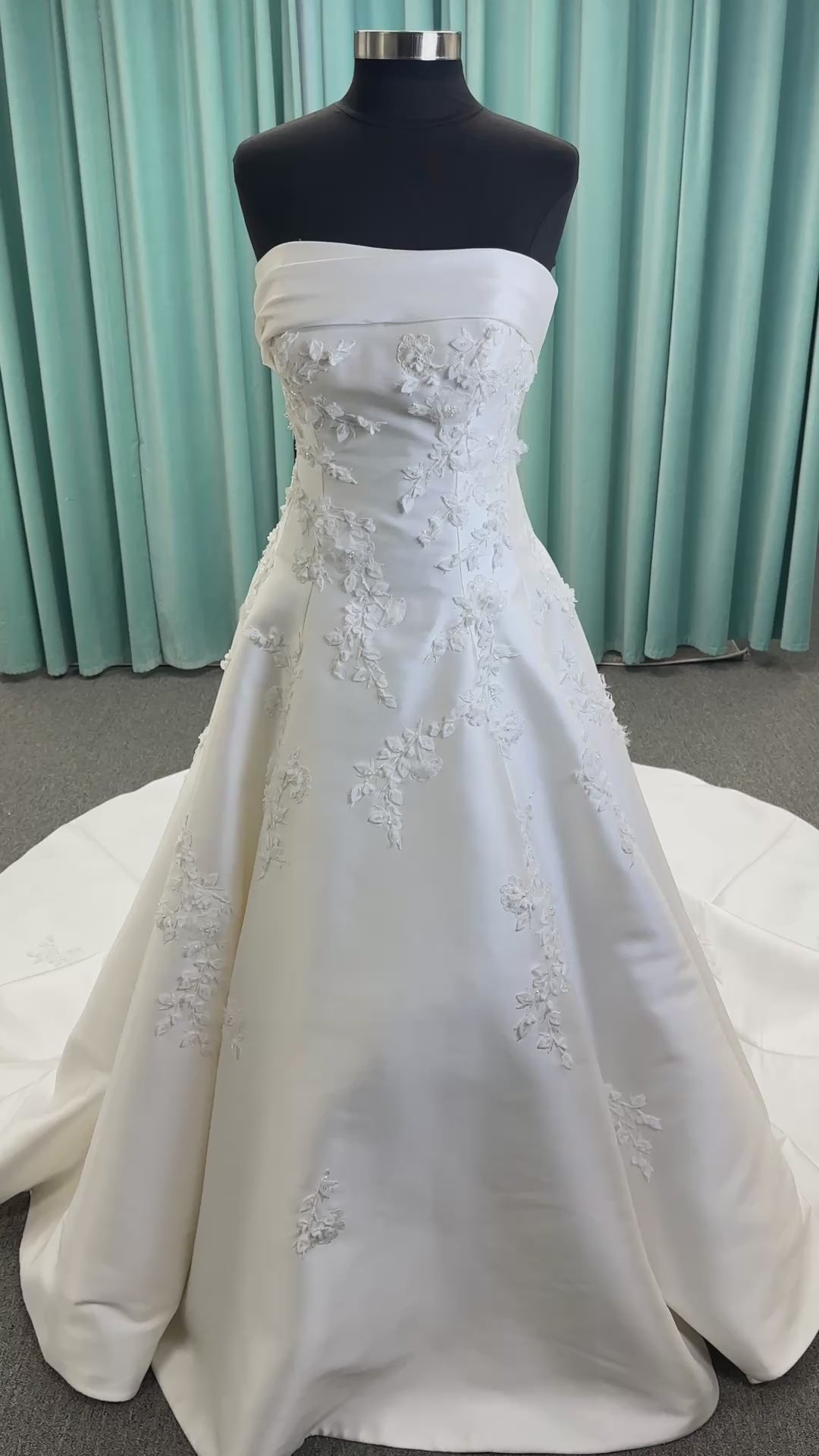 Essense of Australia D4195 ivory lace and Mikado drop-waist wedding dress on mannequin with strapless square neckline, 3D appliqué bodice, and A-line skirt.
