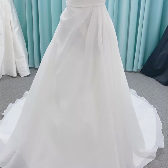 Morilee 2989 Helenia contemporary strapless A-line wedding dress in draped organza with detachable bow and sweeping train.