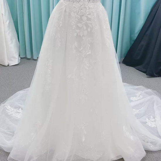 Morilee 2979 Filippa A-line wedding dress in glitter tulle with plunge sweetheart bodice, sequin beaded threadwork appliqués, detachable off-shoulder straps, and front slit.
