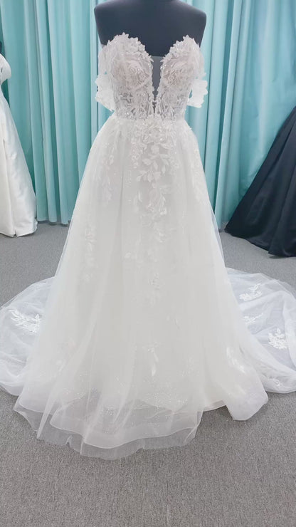 Morilee 2979 Filippa A-line wedding dress in glitter tulle with plunge sweetheart bodice, sequin beaded threadwork appliqués, detachable off-shoulder straps, and front slit.