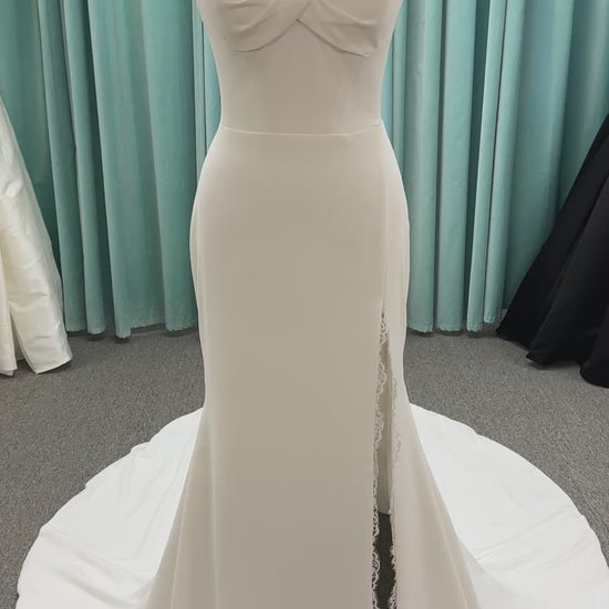 Morilee Scottie wedding dress Style 2711 with off-the-shoulder neckline, twist draped bodice, and lace-trimmed sheath skirt with slit