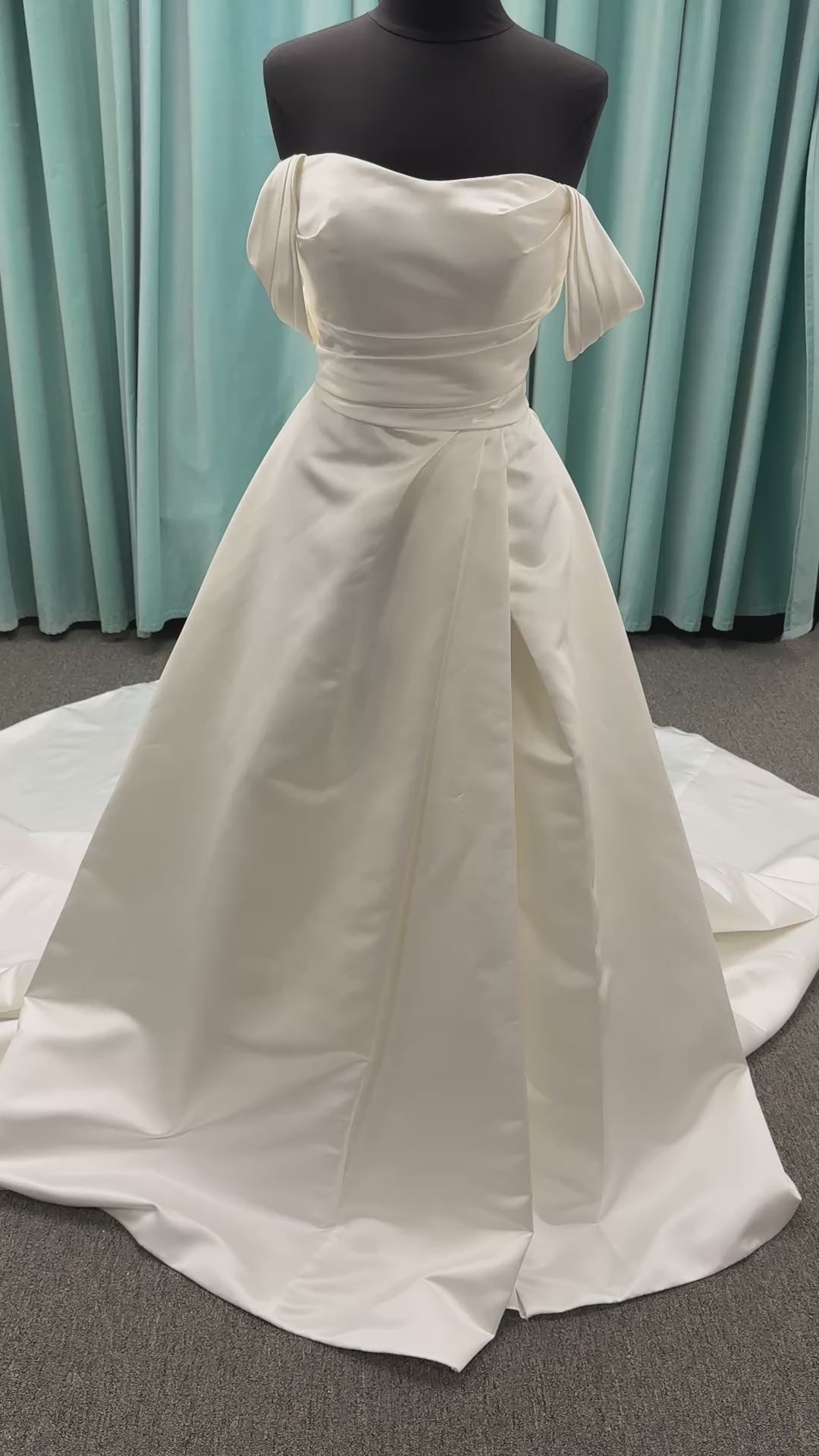Off-the-shoulder satin A-line wedding dress with detachable straps, leg slit, pockets, and embroidered floral detailing by Essense of Australia style D4187