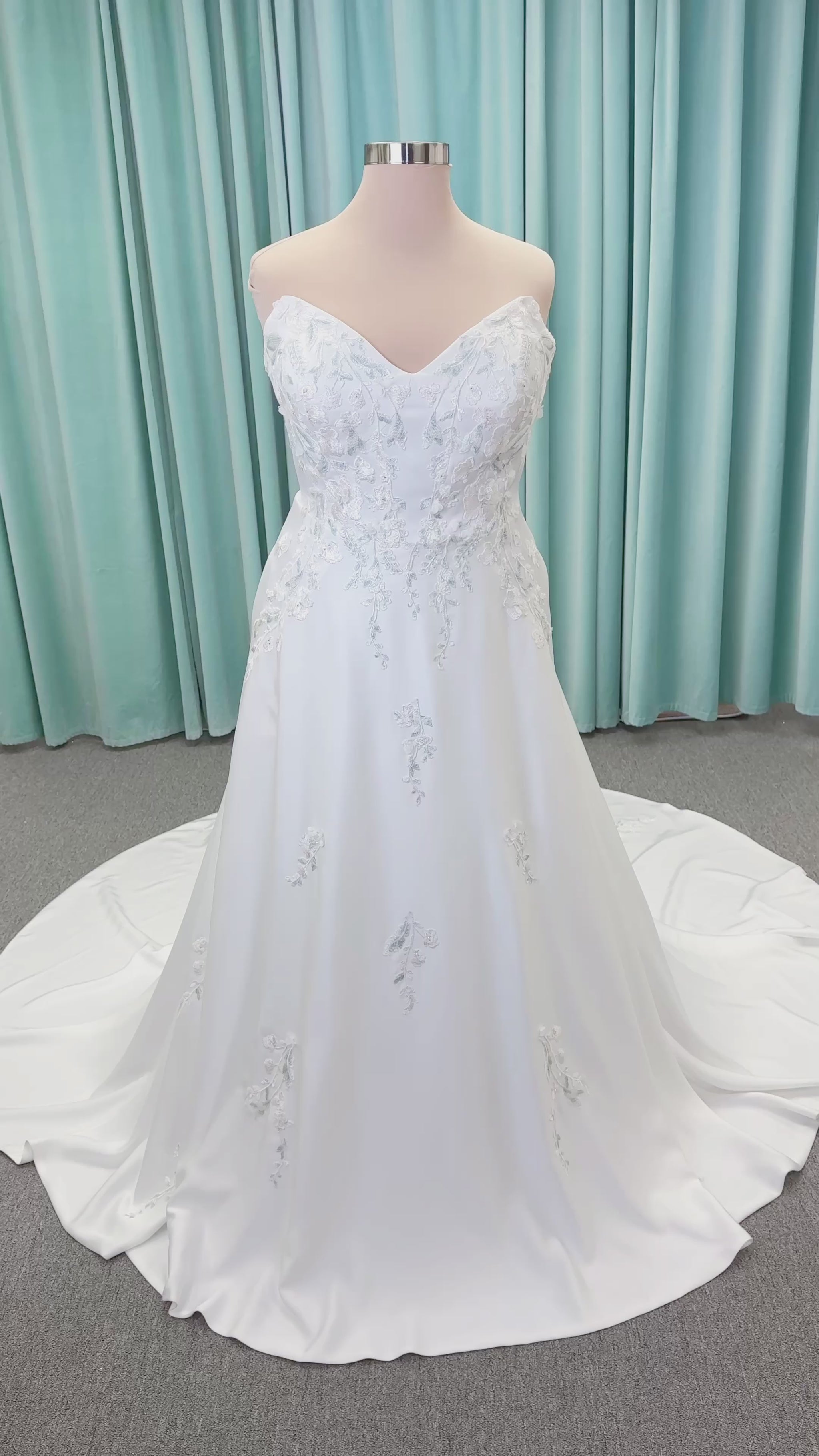 Morilee 4471 Roberta plus size wedding dress on mannequin with angular strapless neckline, 3D floral beaded embroidery, and satin A-line skirt
