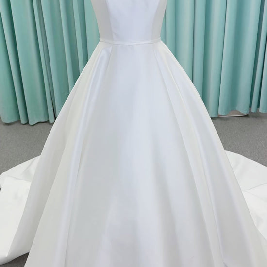 Morilee 2996 Eowyn A-line wedding dress on mannequin with square neckline, slender straps, Mikado fabric, and pockets
