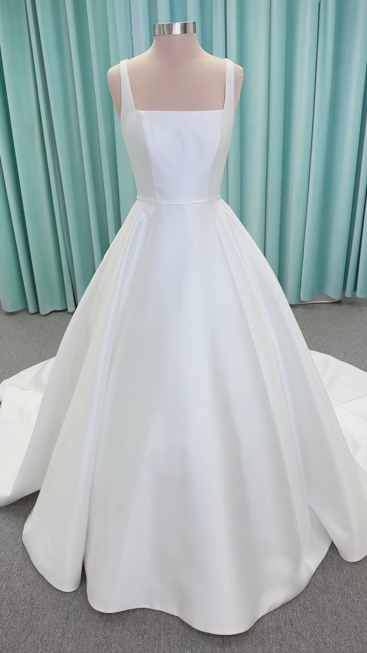 Morilee 2996 Eowyn A-line wedding dress on mannequin with square neckline, slender straps, Mikado fabric, and pockets