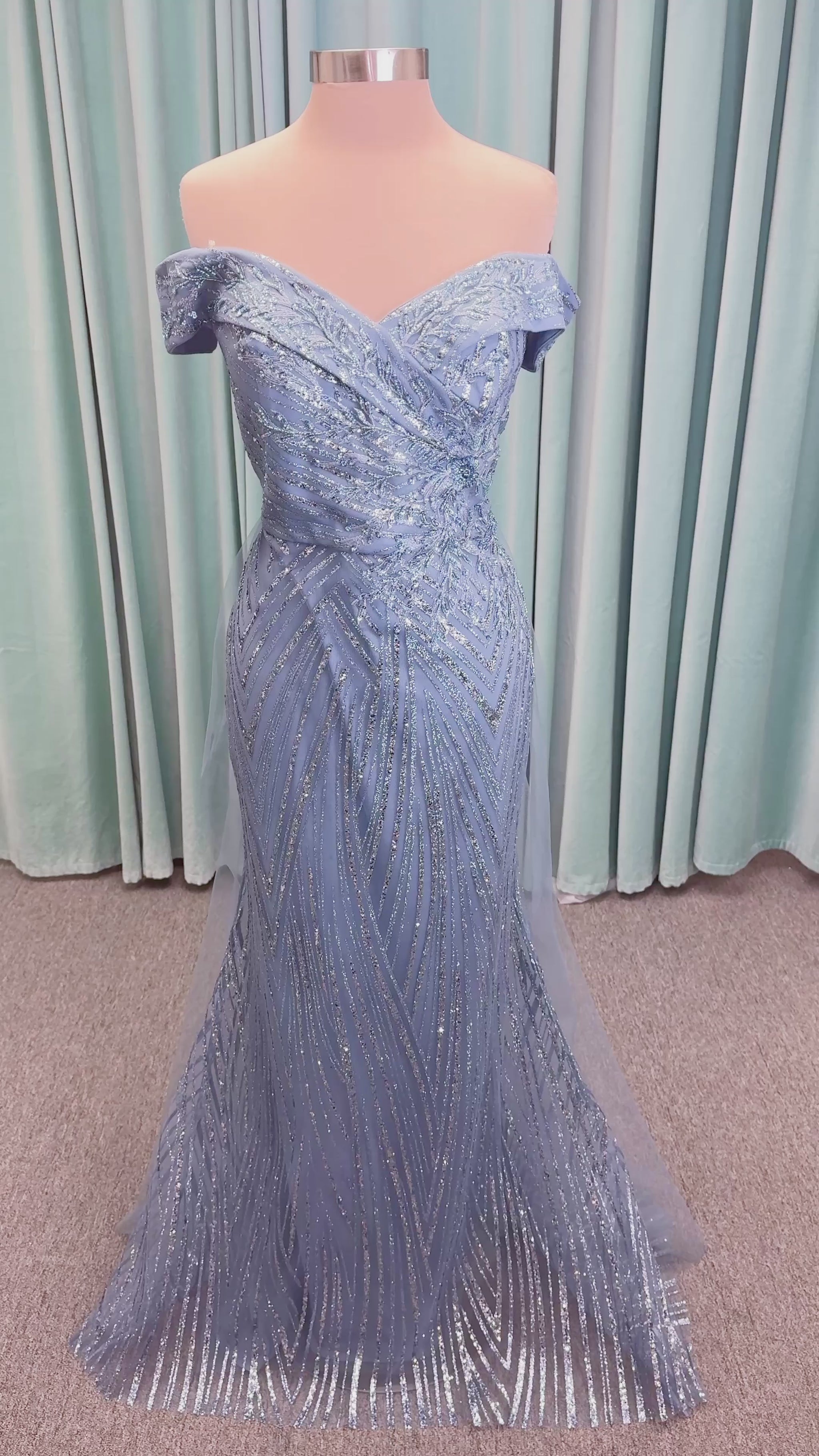 Morilee MLNY 73110 mermaid mother of the bride dress on mannequin with off-the-shoulder sweetheart neckline with foldover cuff, sequin-beaded net bodice, sheer tulle back panel, and sweep train