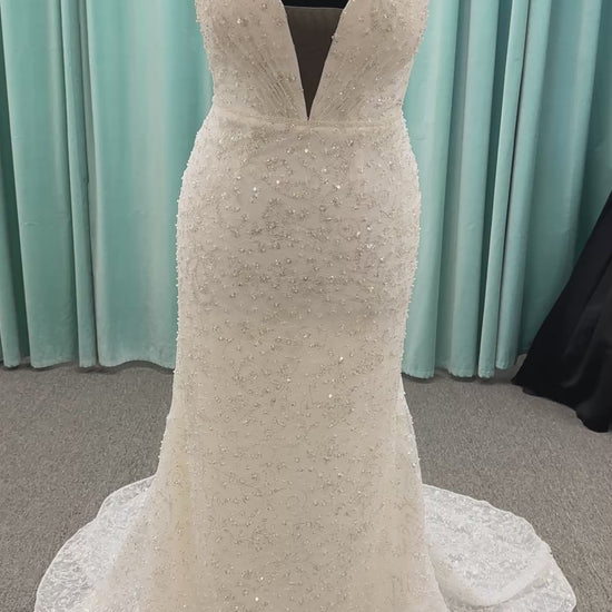 Plus size beaded lace column wedding dress with plunging V neckline, illusion tulle inset, and low V back by Stella York Style 8006
