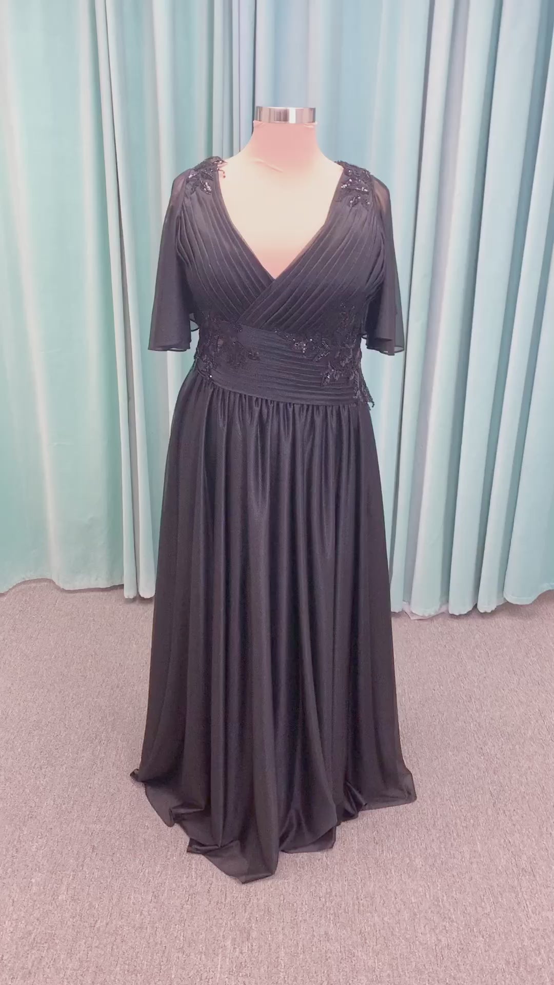 Morilee MLNY 73102 plus size A-line mother of the bride dress on mannequin with asymmetrically draped V-neck bodice, flutter sleeves, embroidered beaded appliques, and shimmer mesh A-line skirt
