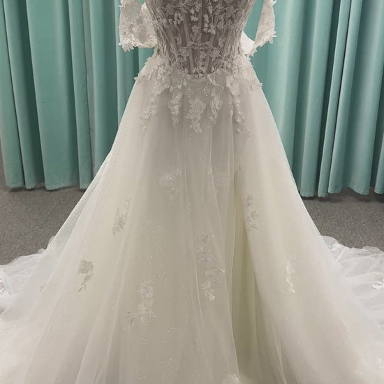 Off-the-shoulder lace A-line wedding dress with corset bodice, 3D floral appliqués, and glitter tulle skirt by Essense of Australia style D4360