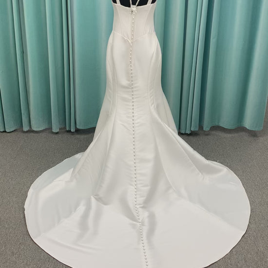 Stella York SY8148 ivory fit-and-flare wedding dress on mannequin featuring a modest scoop neckline, wide straps, and structured corset bodice.

