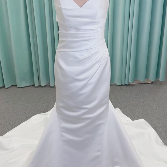 Strapless satin fit-and-flare wedding dress with sweetheart neckline, ruched bodice, fitted hips, and flared chapel-length train.