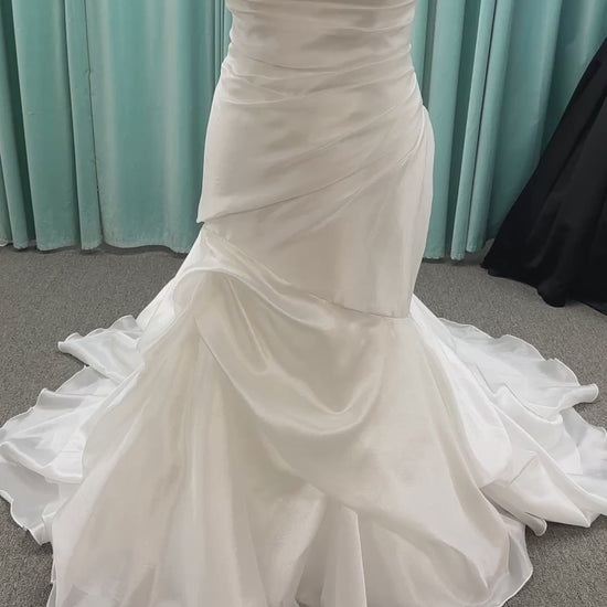 Ruched strapless fit-and-flare wedding dress with cat-eye neckline, asymmetrical skirt, and dramatic pickups by Stella York Style SY8123