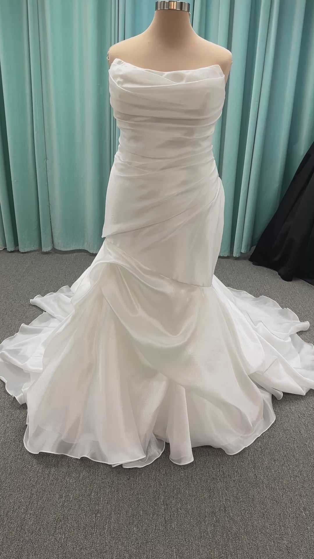 Ruched strapless fit-and-flare wedding dress with cat-eye neckline, asymmetrical skirt, and dramatic pickups by Stella York Style SY8123
