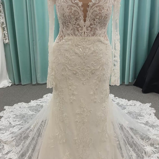 Essense of Australia D4213 lace fit-and-flare wedding dress with plunging neckline and sheer lace sleeves featuring a long lace train