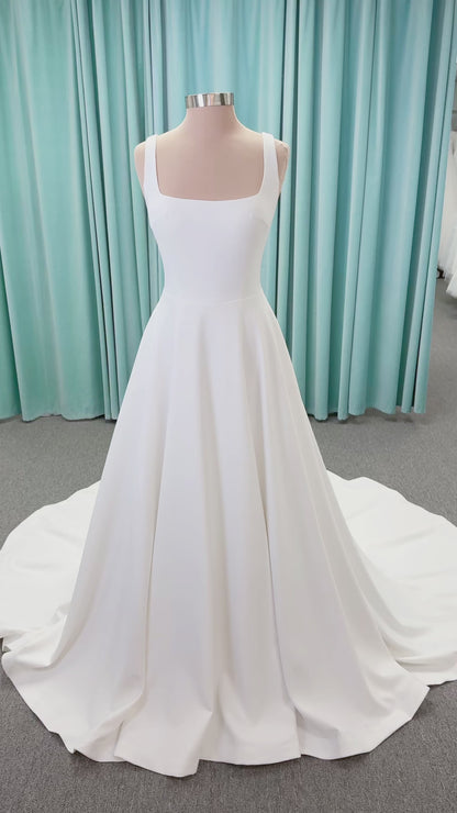 A-Line Ivory wedding dress on mannequin with square neckline and matte crepe A-line skirt