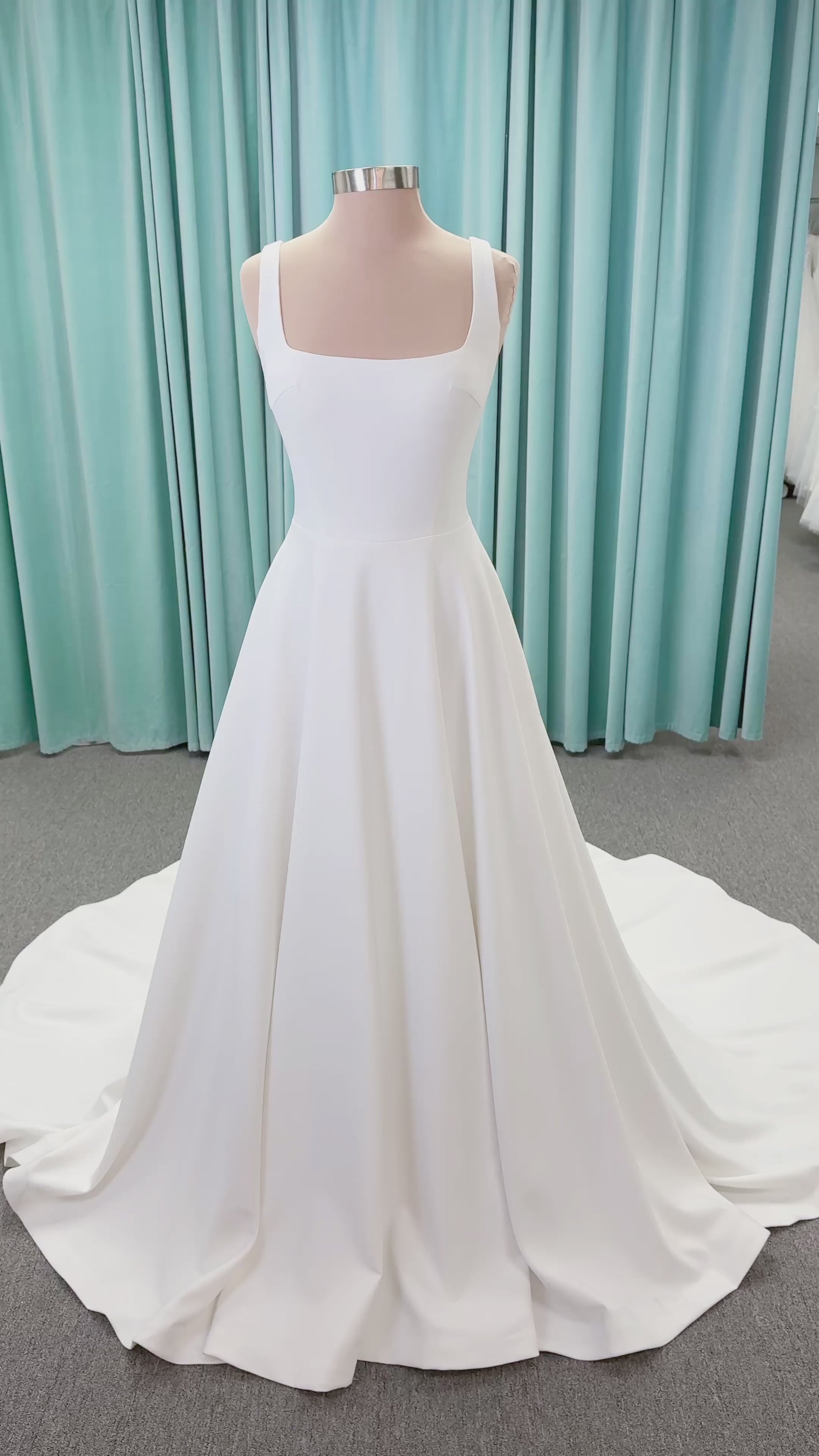 A-Line Ivory wedding dress on mannequin with square neckline and matte crepe A-line skirt