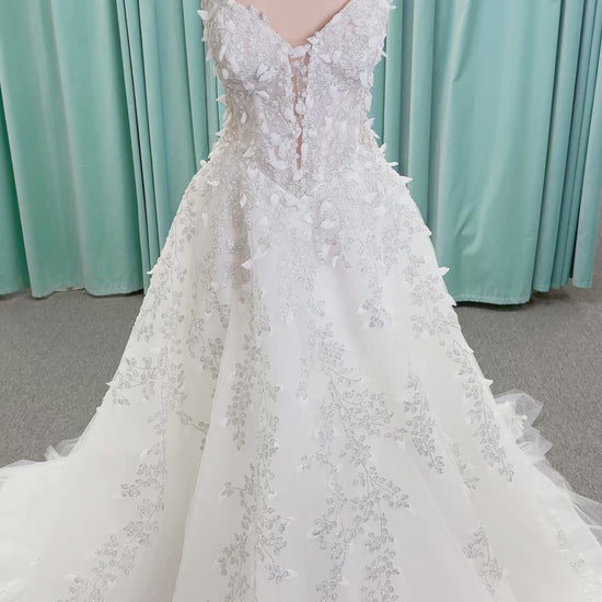 Randy Fenoli Goddess ballgown wedding dress on mannequin with plunging sweetheart neckline, 3D leaf appliqué, basque waist, high skirt slit, and sparkle tulle skirt