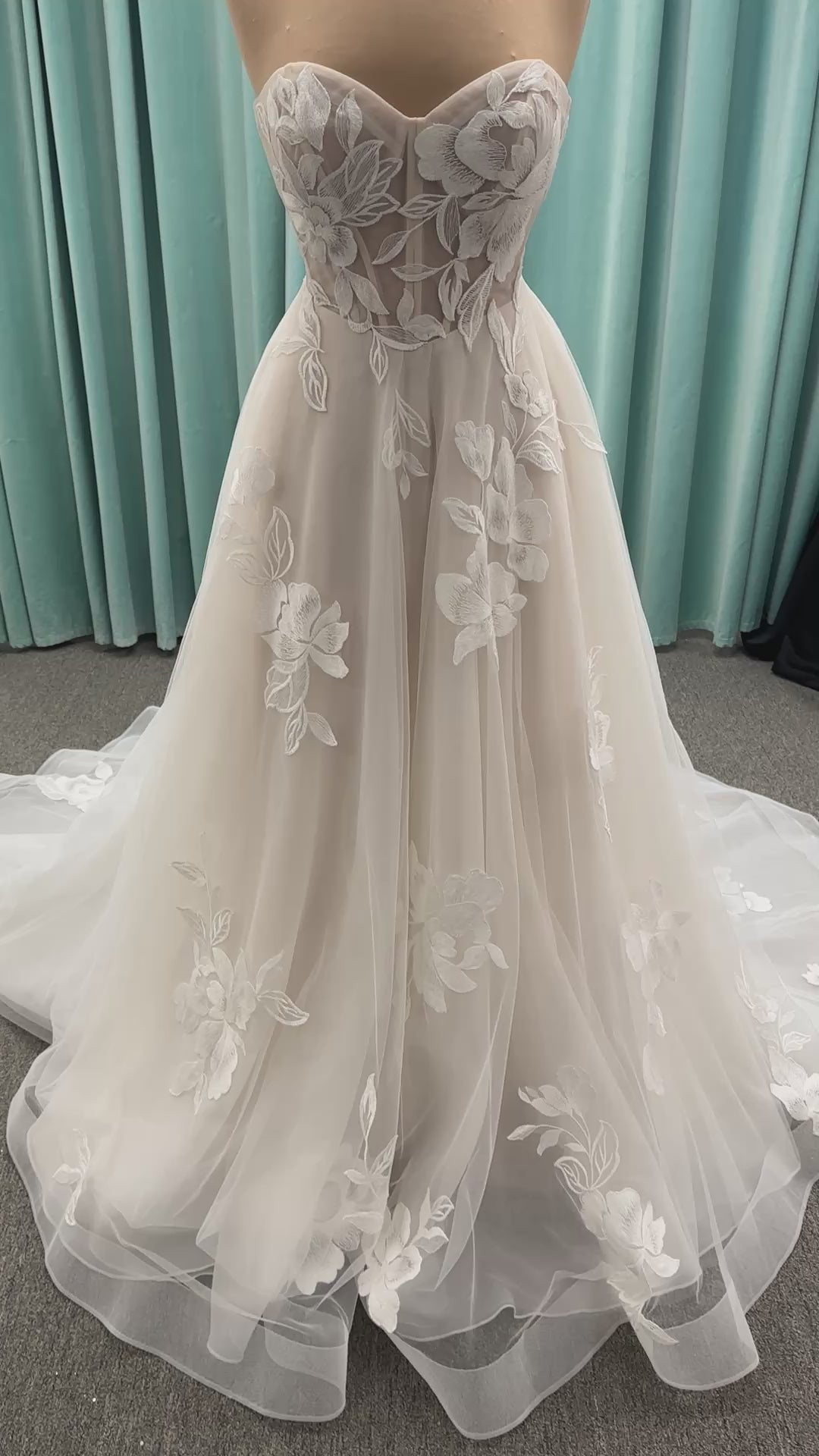 Strapless lace A-line wedding dress with sweetheart neckline, sheer corset bodice, and oversized floral lace appliqués by Stella York Style 7975