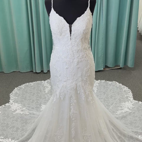 Starr ivory lace fit-and-flare wedding dress on mannequin with sweetheart neckline, delicate straps, and low open back with sweeping train.
