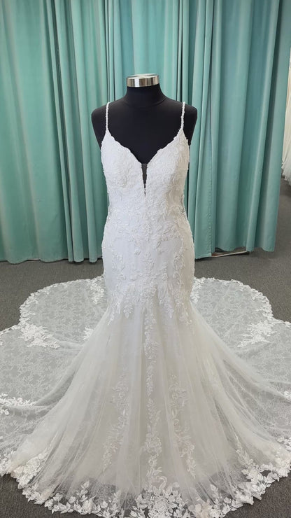 Starr ivory lace fit-and-flare wedding dress on mannequin with sweetheart neckline, delicate straps, and low open back with sweeping train.
