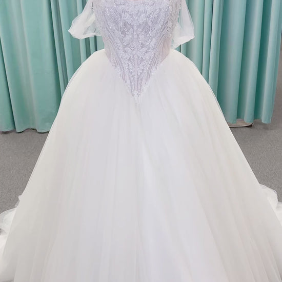 Morilee 1010036 Virtuoso ballgown wedding dress on mannequin with scoop neckline, off-the-shoulder tulle sleeves, beaded bodice, and lace-up corset back